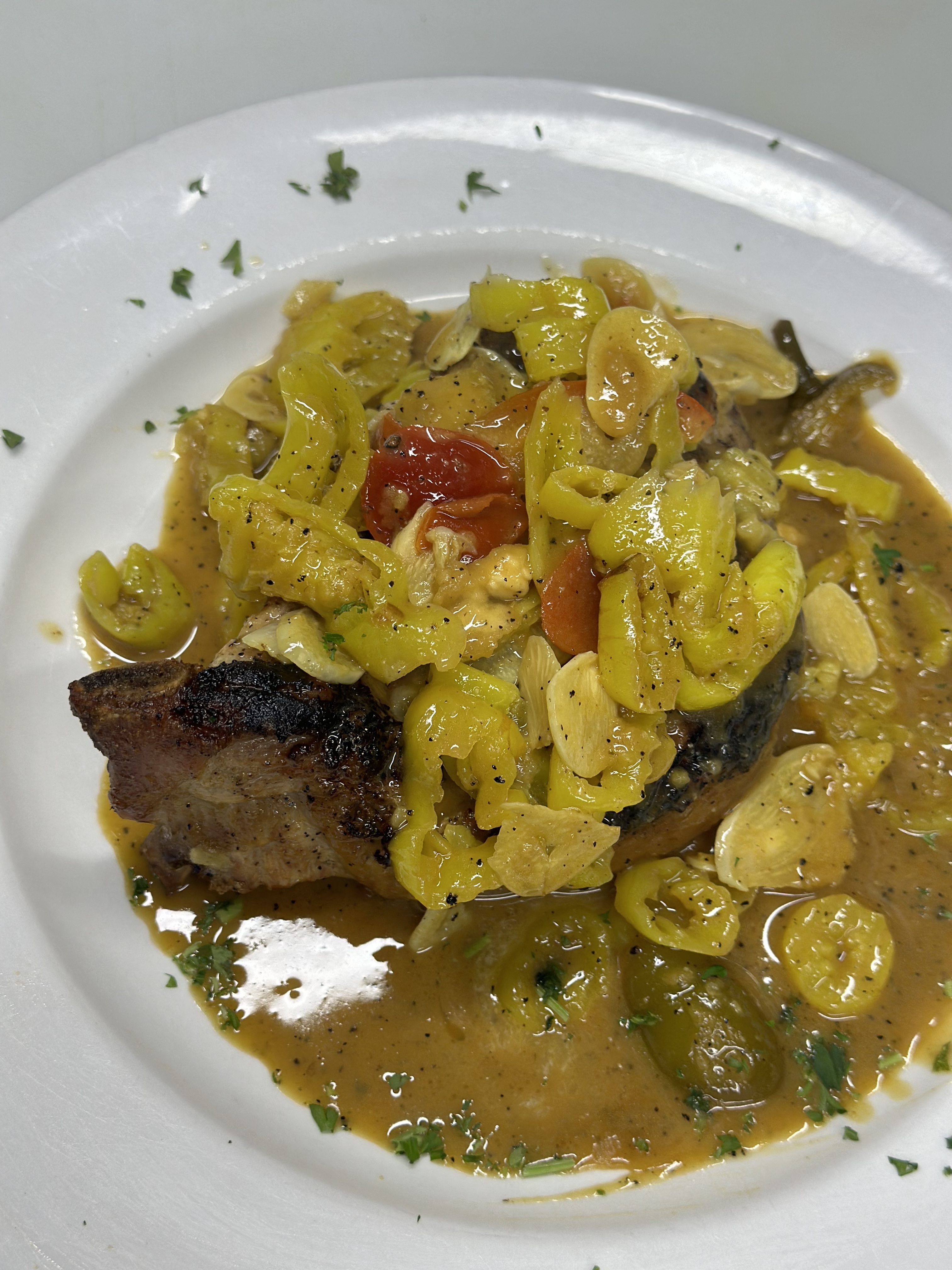 Pork chop with vinegar peppers and mushrooms